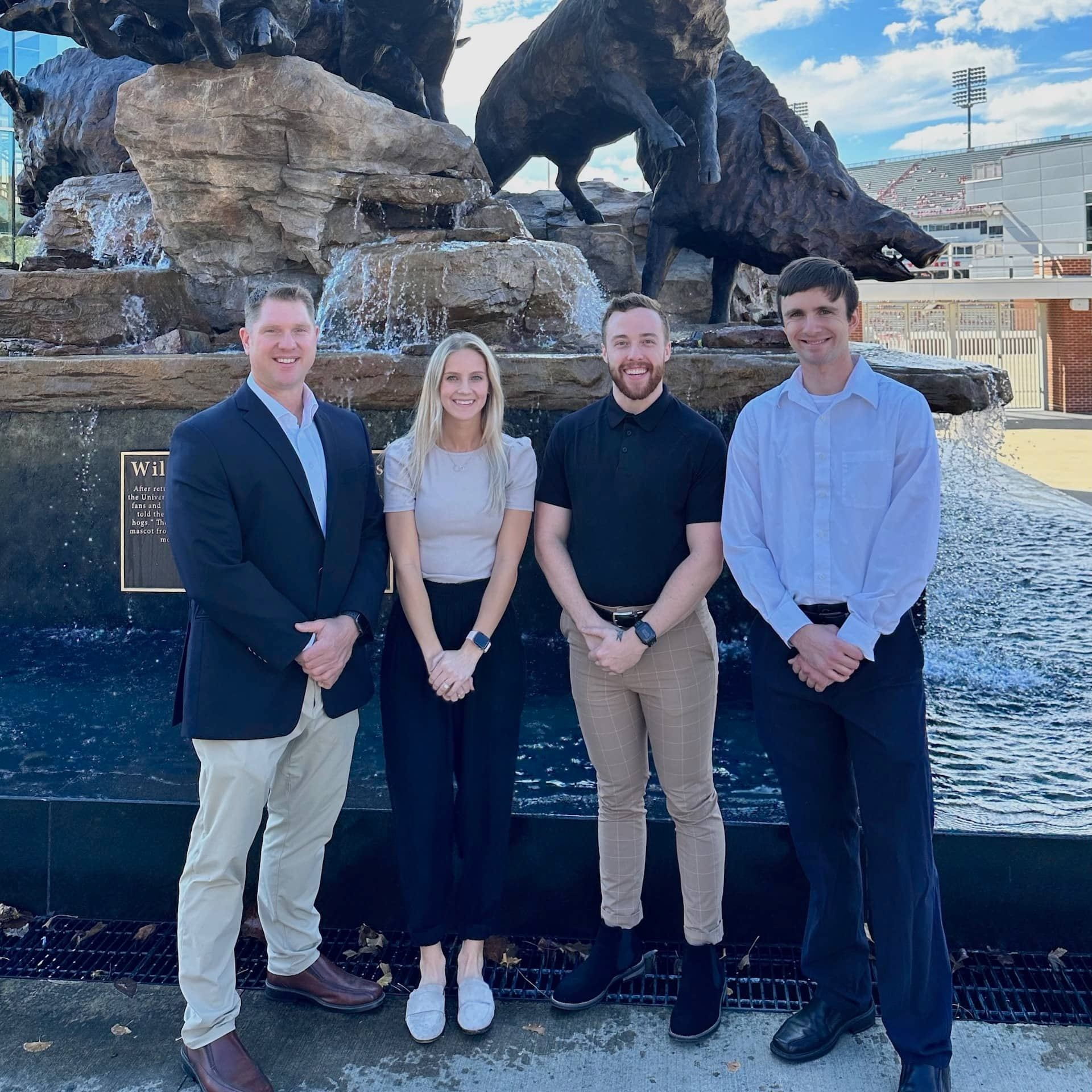 R.J. Elbin, Ph.D., an associate professor of Exercise Science and director of the University of Arkansas Office for Sport Concussion Research, stands with his research graduate assistants Kori Durfee, a Ph.D. candidate, and master's students Adam England and Gary Austin.